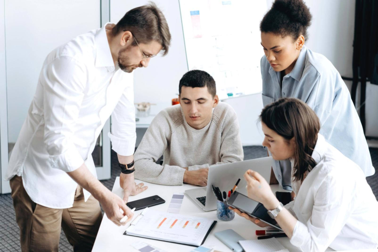 Estudiantes internacionales colaborando en un proyecto de equipo en ambiente universitario